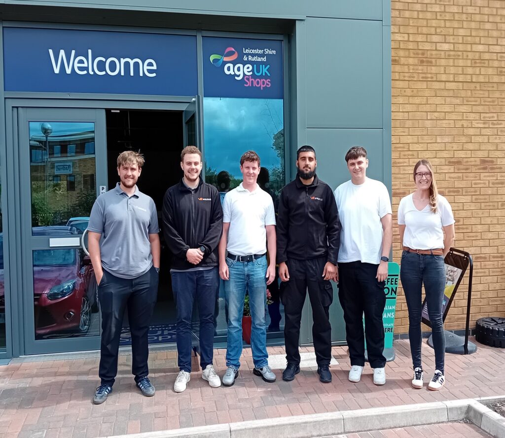 Volunteers from Van Elle and Wates Group arranging shelves and sorting donated items at Age UK Market Harborough to support older people in the community.